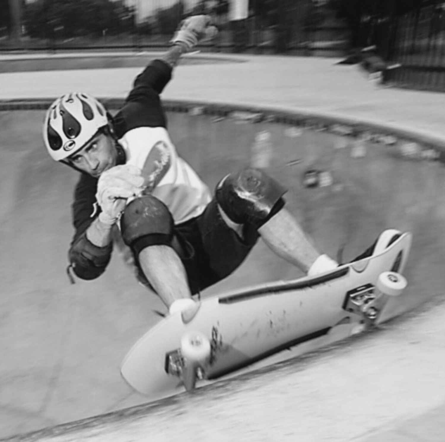 Jay Smith VI carves a pool and grabs his board near the coping in a SoCal bowl.