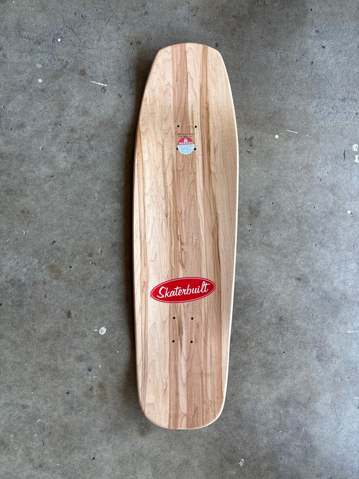 Top view of Skater Built x Death Racer 413 Doug Marker pro model skateboard deck, natural wood finish with Skater Built logo