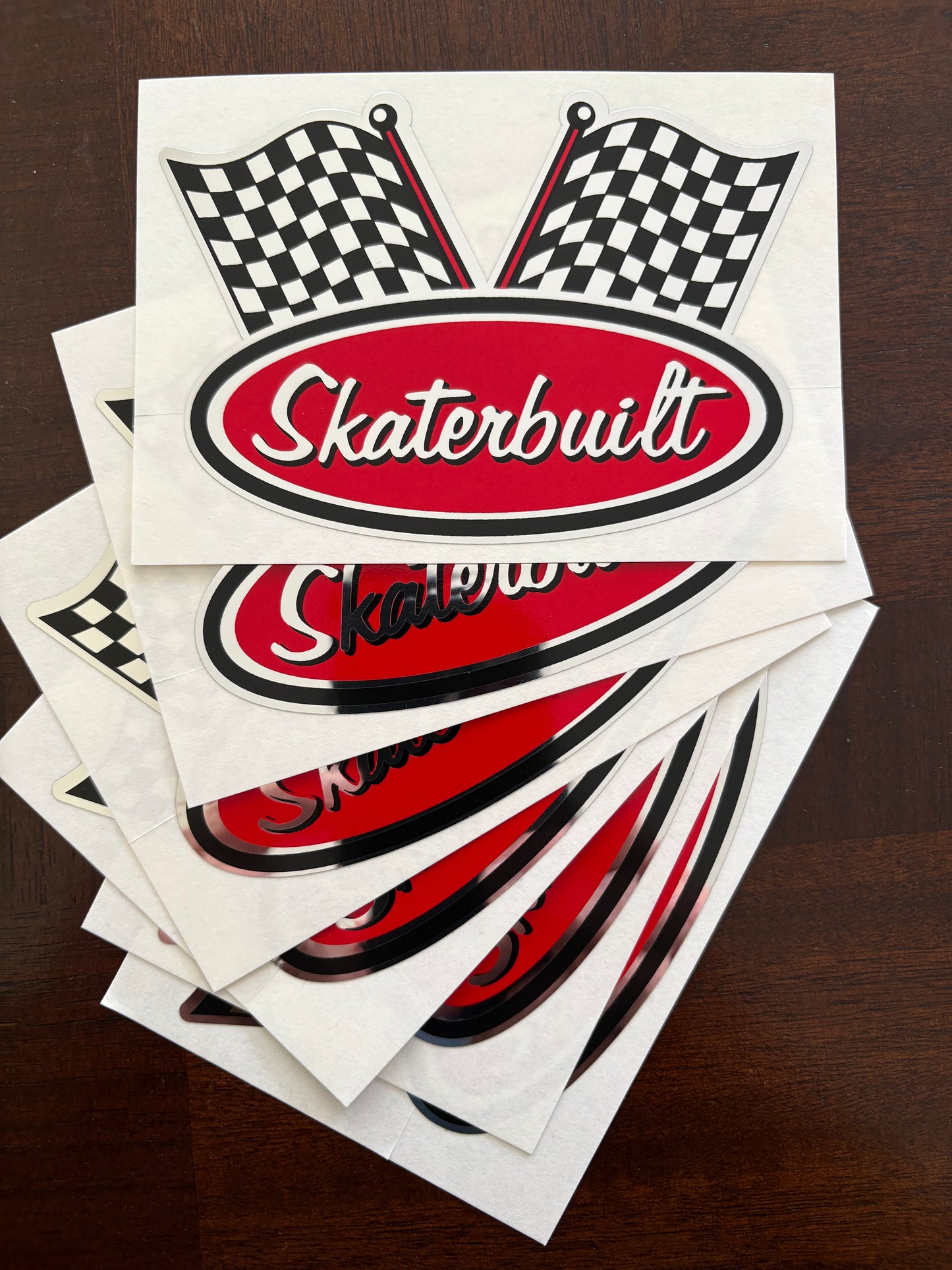 Stack of six Skater Built chrome racing decals, 3.5 inch stickers with Indy 500 checkered flag design