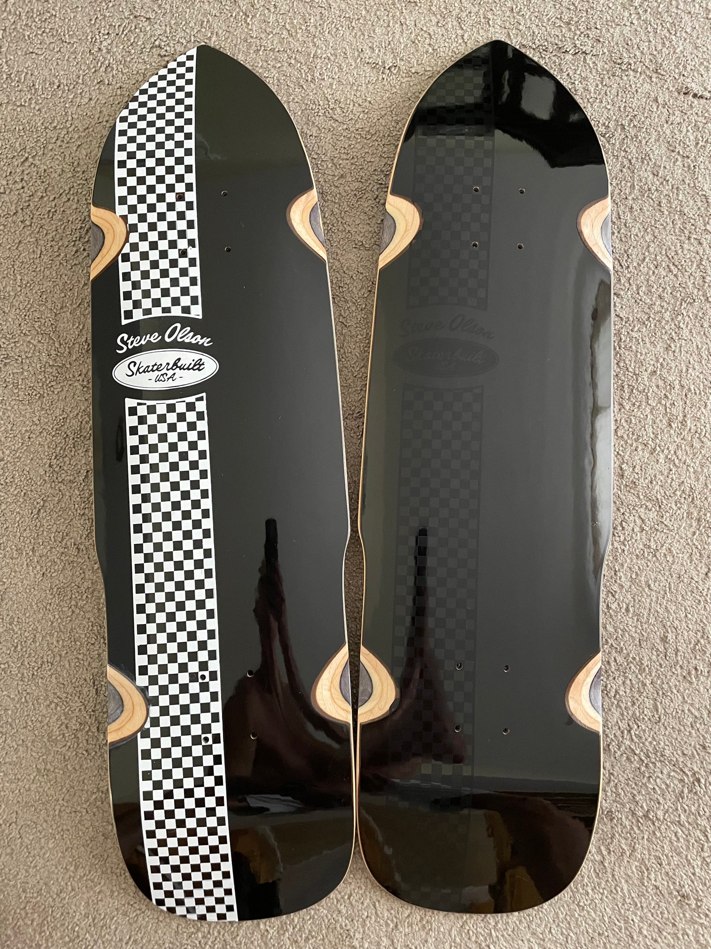 SkaterBuilt x Steve Olson PoolShark collaboration skateboard decks, one with white and black checkered bottom, one with black checkered bottom