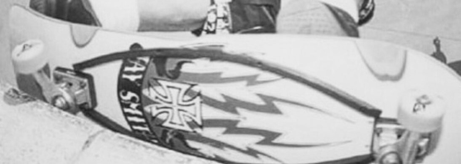 Close-up of the Jay Smith VI Skaterbuilt collaboration deck graphic and trucks along the coping.