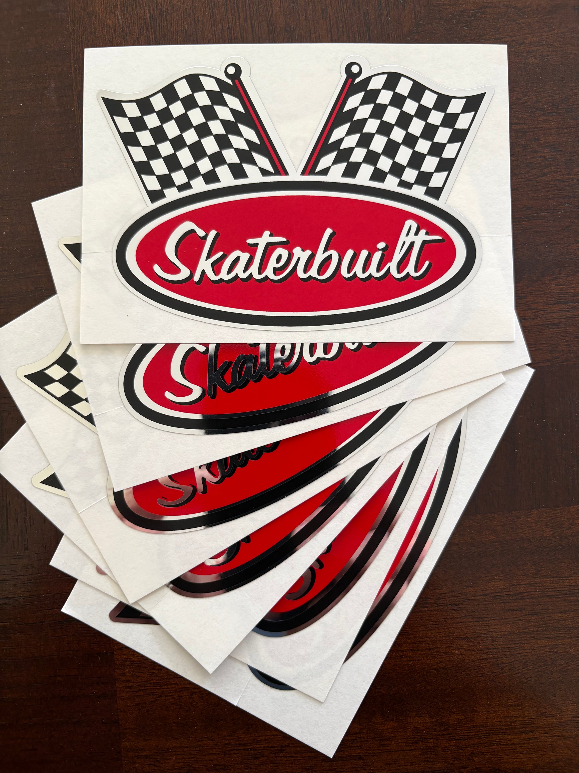 Stack of six Skater Built chrome racing decals, 3.5 inch stickers with Indy 500 checkered flag design