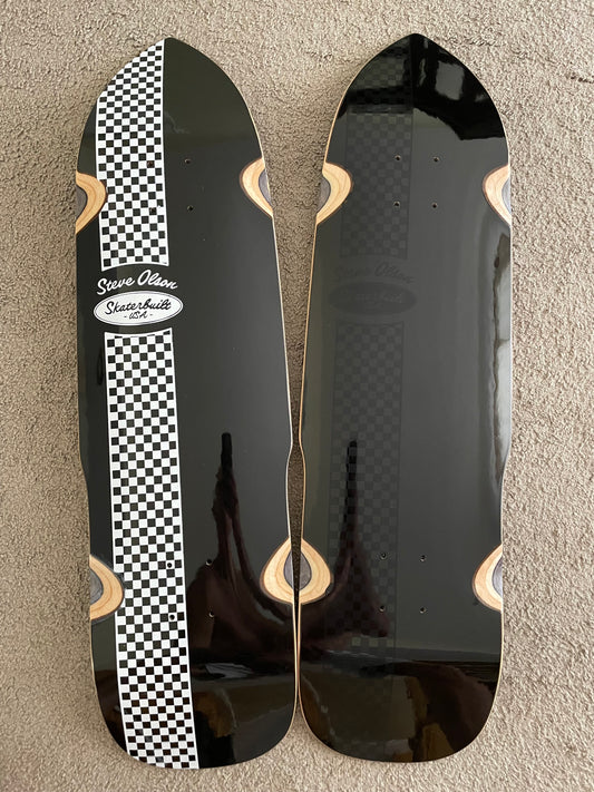 SkaterBuilt x Steve Olson PoolShark collaboration skateboard decks, one with white and black checkered bottom, one with black checkered bottom